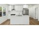 Modern kitchen with white cabinets, stainless steel appliances, and an island with seating at 936 Byron Sw Dr, Atlanta, GA 30310