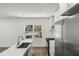 Modern kitchen featuring stainless steel appliances, quartz countertops, and natural light from a large window at 936 Byron Sw Dr, Atlanta, GA 30310