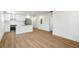 Open kitchen with white cabinets, stainless steel appliances, and wood flooring at 936 Byron Sw Dr, Atlanta, GA 30310