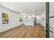 Bright living room and kitchen area showcasing hardwood flooring, recessed lighting, and a view to the exterior at 936 Byron Sw Dr, Atlanta, GA 30310