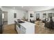 Open concept floor plan showcasing living room and stainless kitchen with white countertops and hardwood floors at 936 Byron Sw Dr, Atlanta, GA 30310