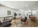 Open-concept living room and kitchen featuring wood floors, stainless steel appliances, and modern decor at 936 Byron Sw Dr, Atlanta, GA 30310