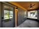 View of home's covered porch with a ceiling fan, exterior lighting and gray front door at 936 Byron Sw Dr, Atlanta, GA 30310