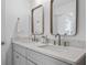Bathroom featuring a double vanity with stone countertops, modern fixtures, and square framed mirrors at 112 Rosaire Nw Pl, Atlanta, GA 30327