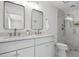 Bright bathroom with double sink vanity, quartz counters and walk-in shower with herringbone tile at 112 Rosaire Nw Pl, Atlanta, GA 30327