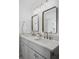 Bathroom featuring a double vanity with stone countertops, modern fixtures, and square framed mirrors at 112 Rosaire Nw Pl, Atlanta, GA 30327