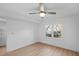 Bright, airy bedroom with wood floors, fan, and a window overlooking lush greenery at 112 Rosaire Nw Pl, Atlanta, GA 30327