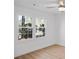 Sun-filled bedroom with wood floors, a modern ceiling fan, and large windows overlooking the backyard at 112 Rosaire Nw Pl, Atlanta, GA 30327