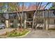 Exterior view of charming townhome with landscaped yard and parking at 112 Rosaire Nw Pl, Atlanta, GA 30327