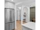 View of a modern kitchen with stainless steel refrigerator, and easy access to dining area and hallways at 112 Rosaire Nw Pl, Atlanta, GA 30327