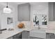 Cozy kitchen with gray cabinets, quartz countertop, and a view to the lush greenery outside the window at 112 Rosaire Nw Pl, Atlanta, GA 30327