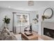 Inviting living room with a cozy fireplace, modern decor, and a window overlooking the outdoors at 112 Rosaire Nw Pl, Atlanta, GA 30327
