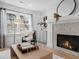 Beautifully decorated living room with a fireplace, comfortable seating, and serene outdoor views at 112 Rosaire Nw Pl, Atlanta, GA 30327