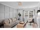 Bright living room featuring a comfortable sofa, stylish decor, and natural light from the window at 112 Rosaire Nw Pl, Atlanta, GA 30327