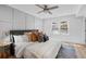 Comfortable bedroom features a ceiling fan, wood floors, paneling, and a view to the outside at 112 Rosaire Nw Pl, Atlanta, GA 30327
