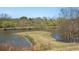 Picturesque pond with a charming island feature, enhancing the community's natural beauty at 112 Rosaire Nw Pl, Atlanta, GA 30327