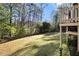 Expansive backyard featuring a lush lawn and wooded area, perfect for outdoor activities and relaxation at 1472 Hartman Sw Dr, Lilburn, GA 30047