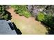 Aerial view showcasing an expansive backyard, mature trees and a well maintained lawn with patio and deck at 1472 Hartman Sw Dr, Lilburn, GA 30047