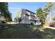 View of the back of the home showing the yard, multi-level decks, and stairs at 1472 Hartman Sw Dr, Lilburn, GA 30047