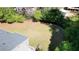 Aerial view of the large backyard with ample space surrounded by mature trees and lush greenery at 1472 Hartman Sw Dr, Lilburn, GA 30047