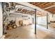 Unfinished basement offers potential for customization with a garage door and lawn equipment at 1472 Hartman Sw Dr, Lilburn, GA 30047