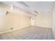 Basement with tile flooring, neutral walls, and a white door for utility access at 1472 Hartman Sw Dr, Lilburn, GA 30047