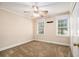 Carpeted bedroom featuring a ceiling fan and two windows with white trim at 1472 Hartman Sw Dr, Lilburn, GA 30047