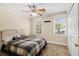 Inviting bedroom with a plaid-covered bed, two windows, and neutral colored walls at 1472 Hartman Sw Dr, Lilburn, GA 30047