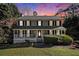 Charming two-story home features a welcoming front porch and beautifully landscaped front yard at 1472 Hartman Sw Dr, Lilburn, GA 30047