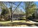 Lovely two-story home with a inviting front porch surrounded by mature trees at 1472 Hartman Sw Dr, Lilburn, GA 30047