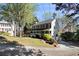 Well-maintained home with a long driveway and lush landscaping at 1472 Hartman Sw Dr, Lilburn, GA 30047