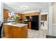 Bright kitchen showcasing wooden cabinets, granite countertops and modern black appliances at 1472 Hartman Sw Dr, Lilburn, GA 30047
