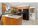 Charming kitchen featuring wooden cabinets, tile backsplash, and a breakfast bar island at 1472 Hartman Sw Dr, Lilburn, GA 30047