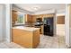 Kitchen featuring tile floor, island and modern appliances at 1472 Hartman Sw Dr, Lilburn, GA 30047