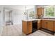 Eat-in kitchen with tiled floors, island, and backyard view at 1472 Hartman Sw Dr, Lilburn, GA 30047