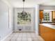 Eat-in kitchen with tiled floors and modern hanging light at 1472 Hartman Sw Dr, Lilburn, GA 30047