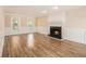 Open living room featuring a fireplace and wood floors at 1472 Hartman Sw Dr, Lilburn, GA 30047