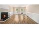 Bright living room features a fireplace and hardwood floors at 1472 Hartman Sw Dr, Lilburn, GA 30047