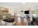 Cozy living room featuring a fireplace, hardwood floors, and comfortable seating at 1472 Hartman Sw Dr, Lilburn, GA 30047