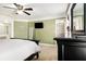 Brightly lit primary bedroom with green walls and an en suite bathroom at 1472 Hartman Sw Dr, Lilburn, GA 30047