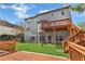 Spacious backyard featuring a wooden deck, lush green grass, and a well-maintained lawn at 3670 Cedar Springs Ln, Loganville, GA 30052