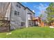 Large backyard with wooden deck and stairs and plentiful green grass at 3670 Cedar Springs Ln, Loganville, GA 30052
