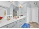 Well-lit bathroom featuring double sinks, a large mirror, and modern fixtures for a clean and stylish look at 3670 Cedar Springs Ln, Loganville, GA 30052