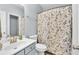 Bathroom features a shower and tub combination with a white and green decorative shower curtain at 3670 Cedar Springs Ln, Loganville, GA 30052