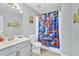 Bathroom features a shower and tub combination with a colorful Looney Tunes shower curtain at 3670 Cedar Springs Ln, Loganville, GA 30052