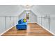 Attic Bonus room with hardwood floors, natural lighting, and a stylish blue sofa for relaxation at 3670 Cedar Springs Ln, Loganville, GA 30052