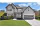 Charming two-story home with gray siding, manicured lawn, and an attached two-car garage at 3670 Cedar Springs Ln, Loganville, GA 30052