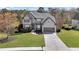 Inviting two-story house boasts lush lawn, gray facade, two-car garage, and a welcoming driveway at 3670 Cedar Springs Ln, Loganville, GA 30052