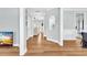 Bright hallway features hardwood floors, blue walls, white trim, and archway leading to the living areas at 3670 Cedar Springs Ln, Loganville, GA 30052