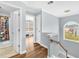 Upstairs landing showcases hardwood floors, an arched window and doorways to multiple rooms at 3670 Cedar Springs Ln, Loganville, GA 30052